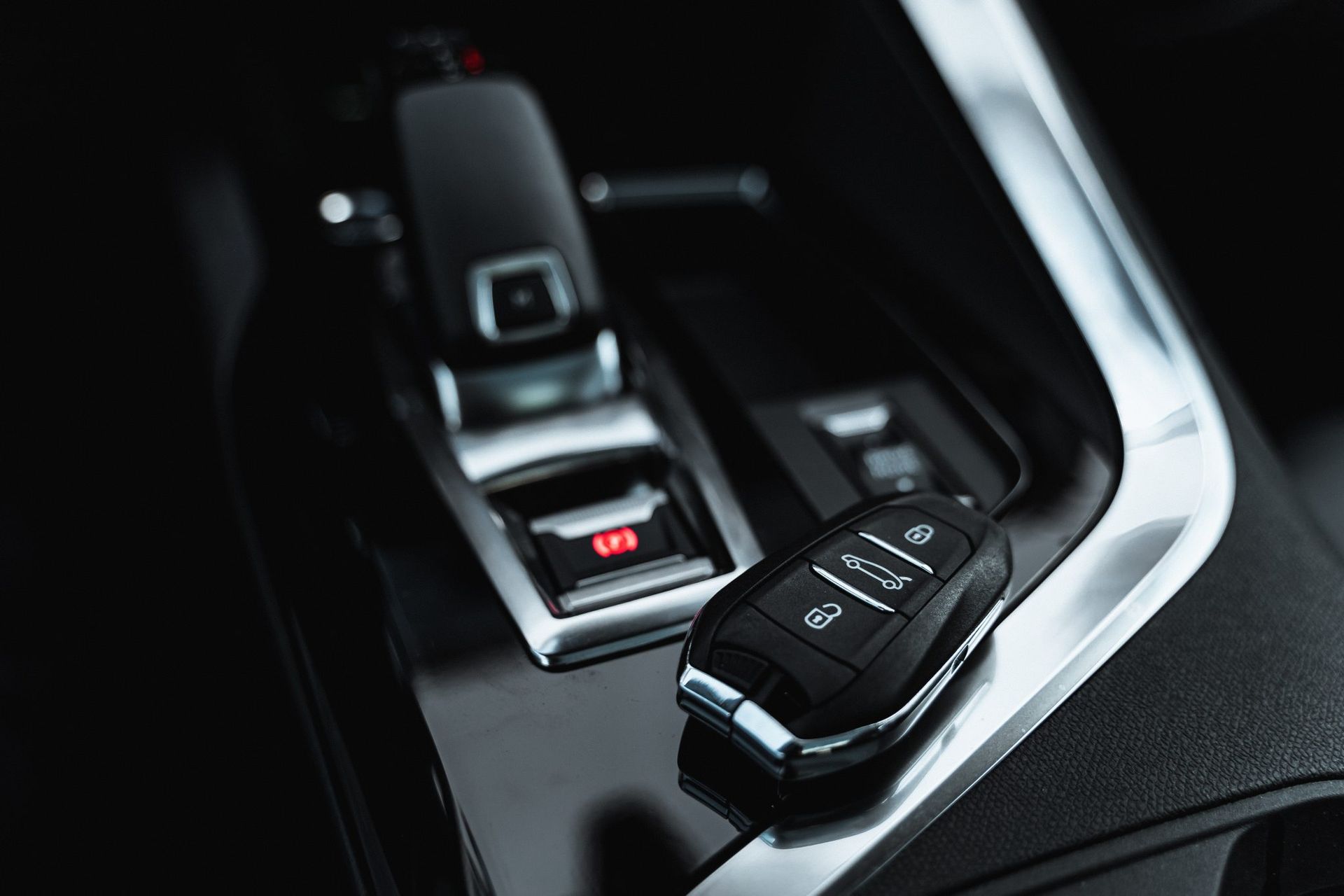 A close up of a car key in the center console of a car - AK Auto Repair