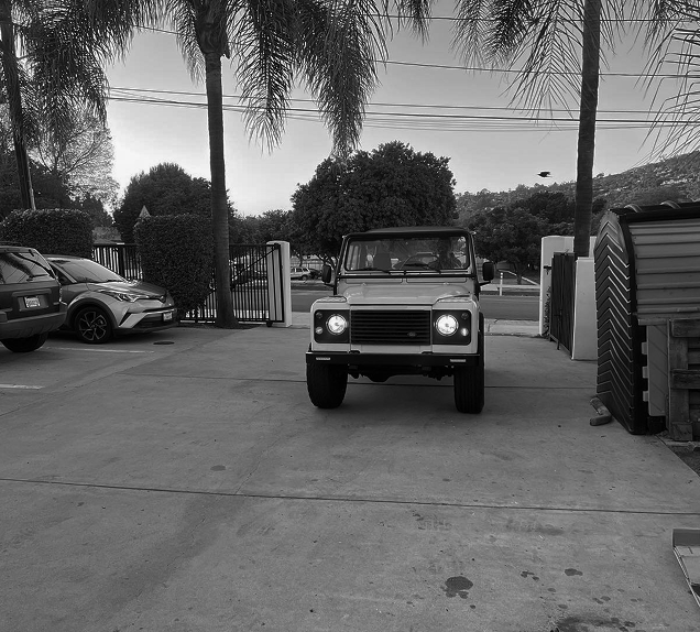 A black and white photo of a jeep parked in a parking lot | AK Auto Repair