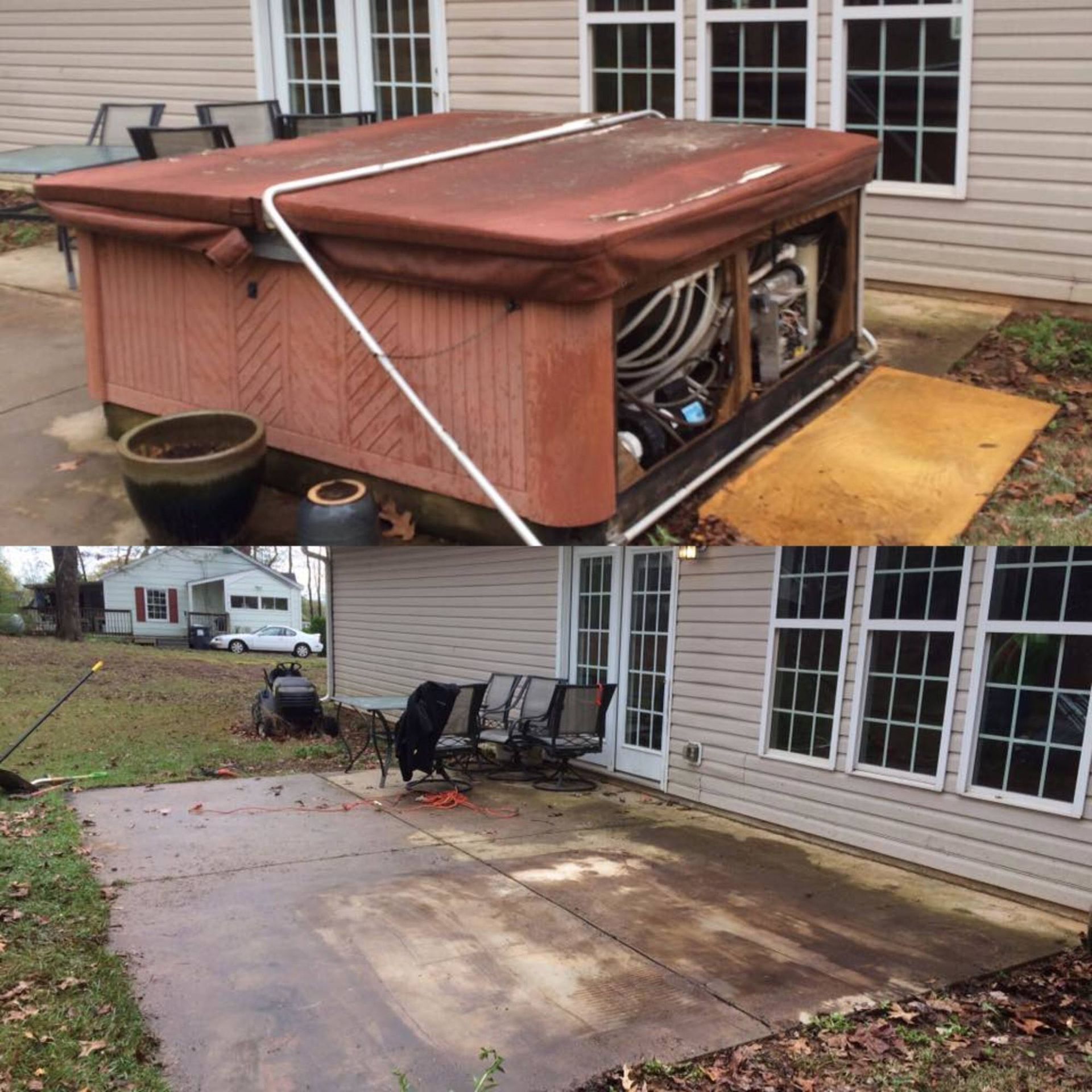 A hot tub is sitting on a patio in front of a house.