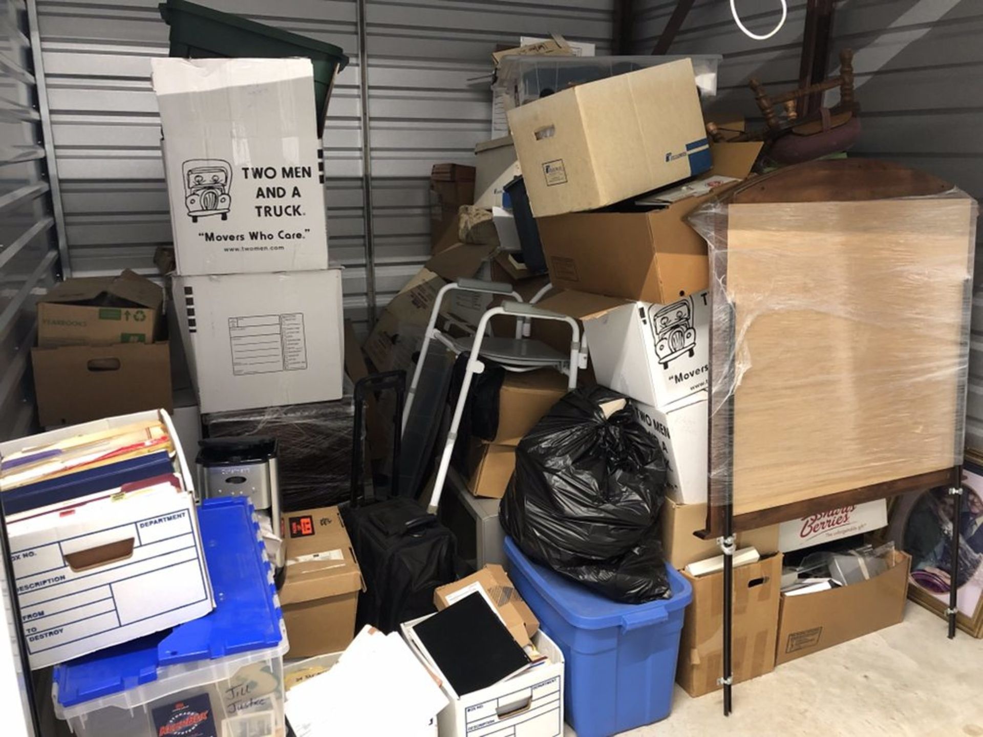 A room filled with lots of boxes and a stack of boxes on top of each other.