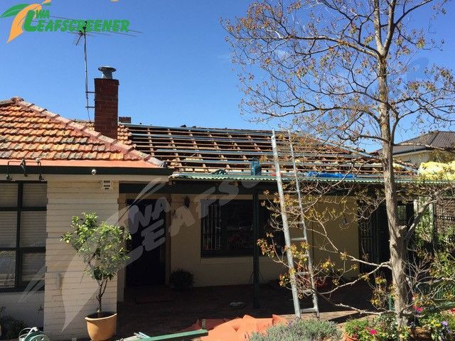 A house with a roof that is being removed