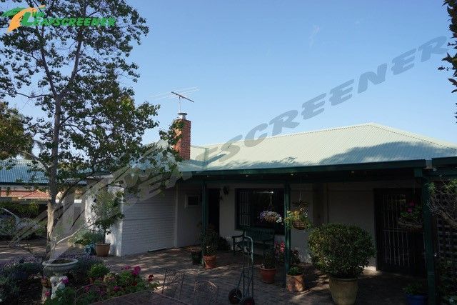 A white house with a green roof and a sign that says screened