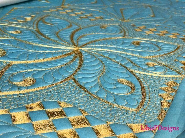 A close up of a blue and gold quilt