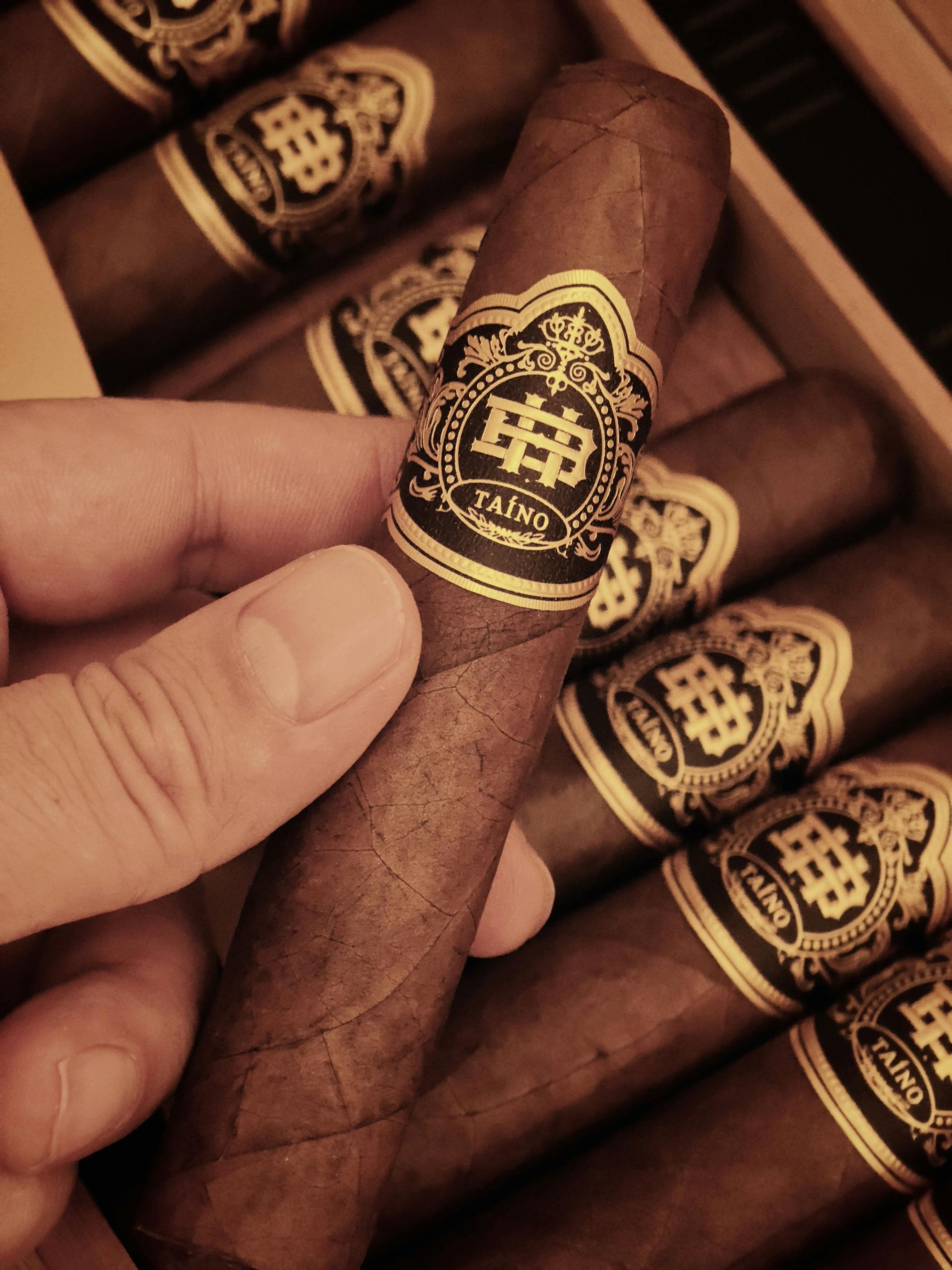 Humidor-themed wax melts in clear packaging on a wooden table with cigars and a lighter