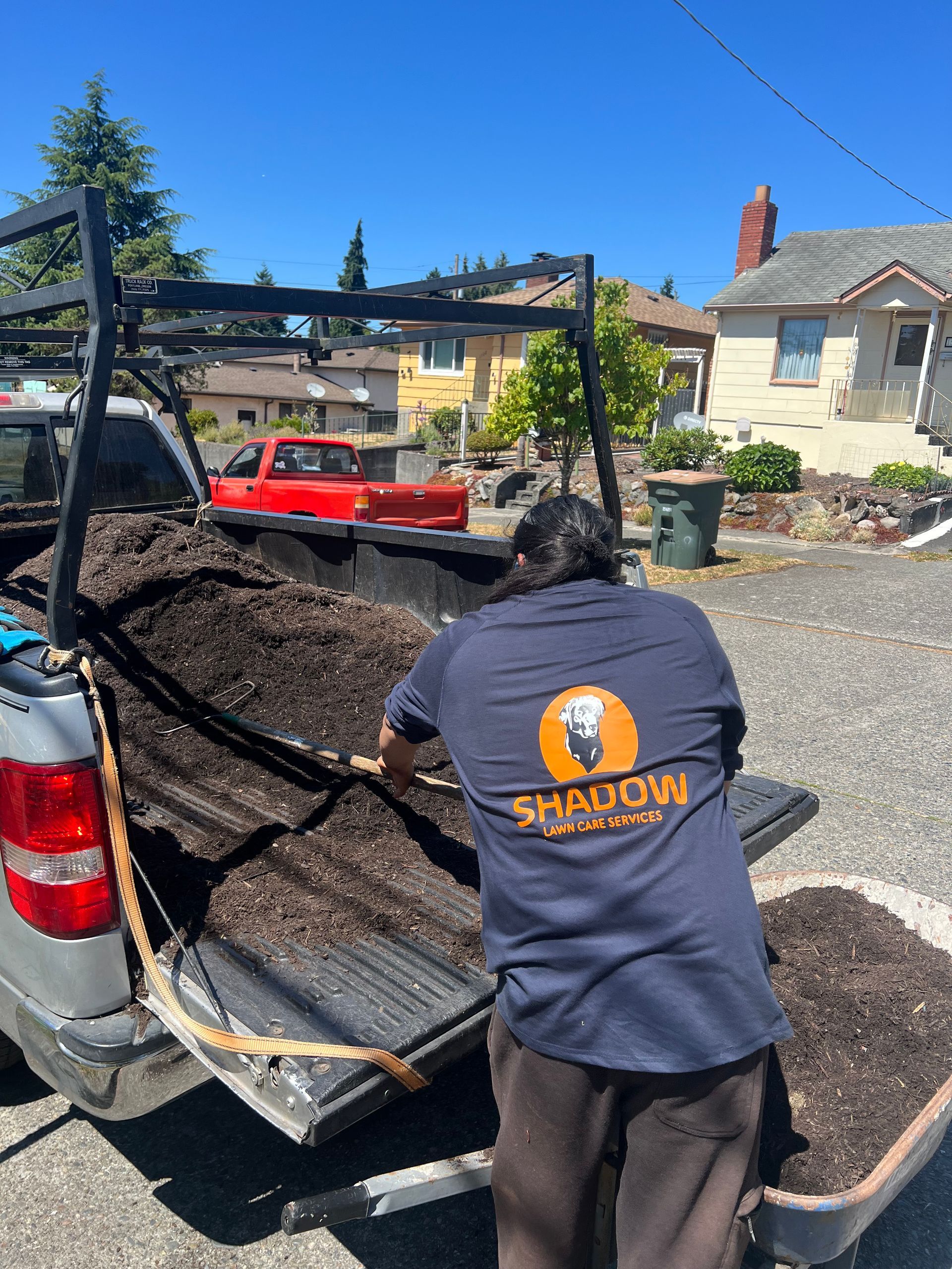 Yellow Cub Cadet zero-turn mower on a black trailer, parked on asphalt.
