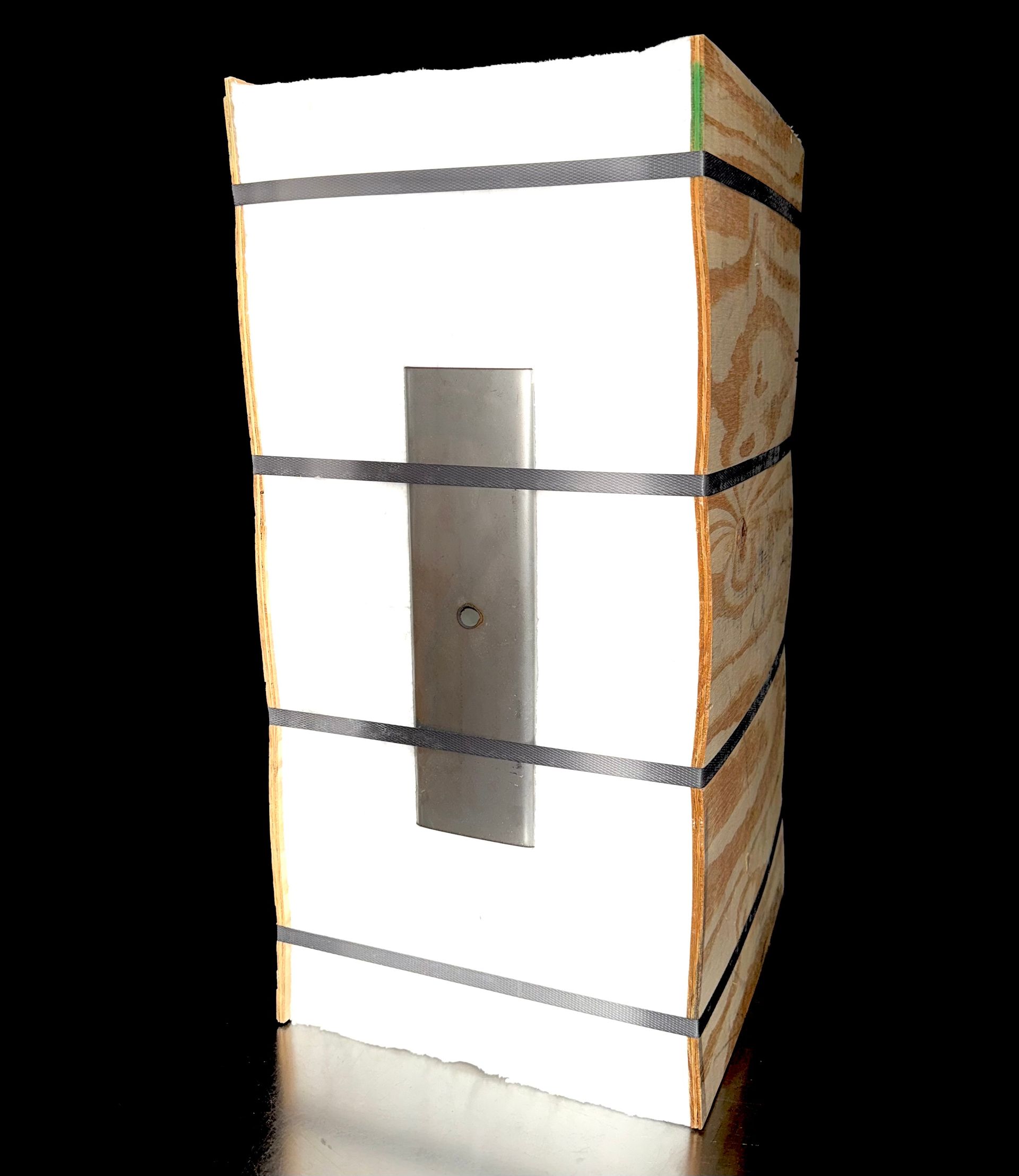 Wooden crate with white front, steel rectangle, and black straps.