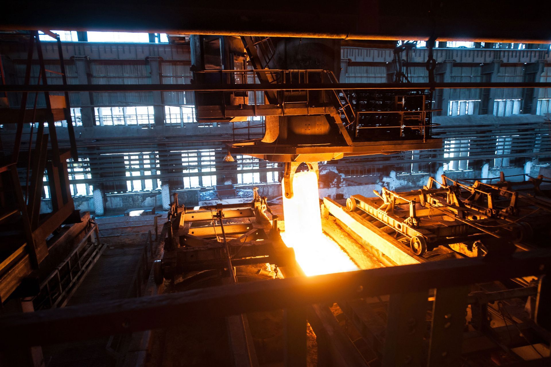 Molten metal pouring in foundry protected by high-grade refractory materials in furnace. Molten metal pouring in foundry protected by high-grade refractory materials in furnace.