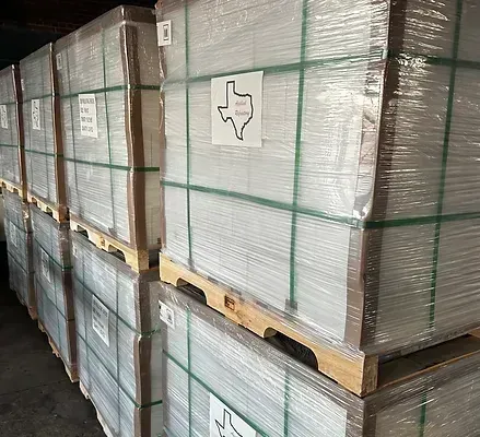 A row of boxes stacked on top of each other on wooden pallets.