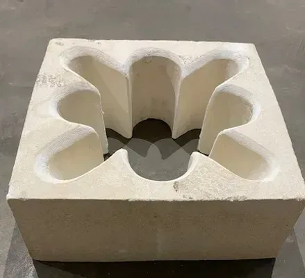 A white brick with holes in it is sitting on a table.