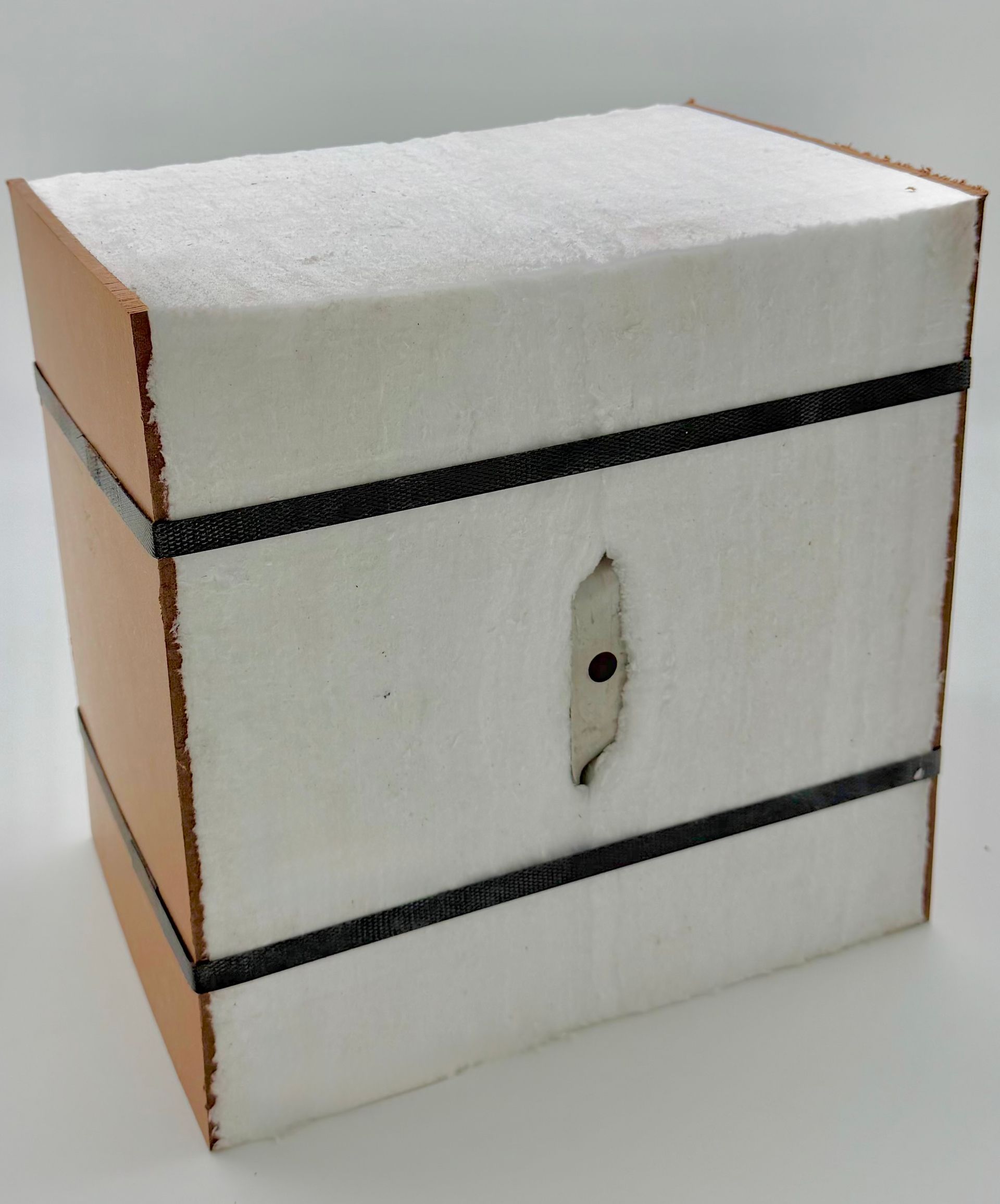 Wooden crate with white front, steel rectangle, and black straps.