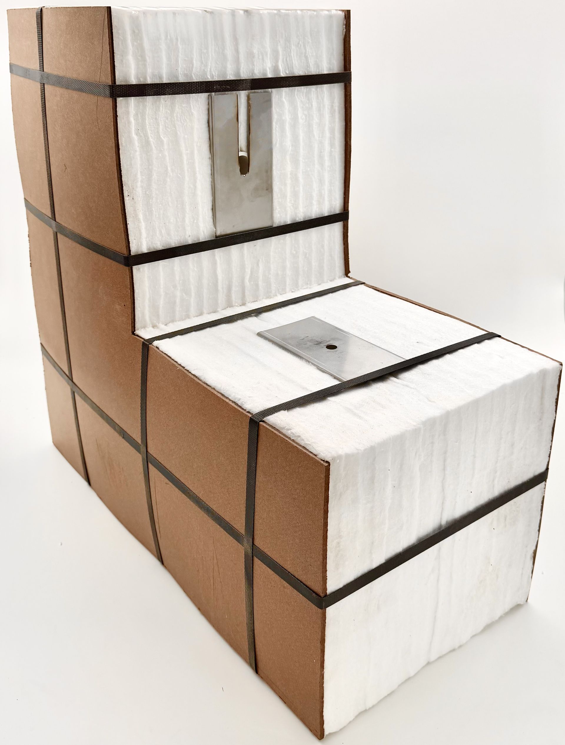 A wooden and fabric package is wrapped with black straps.