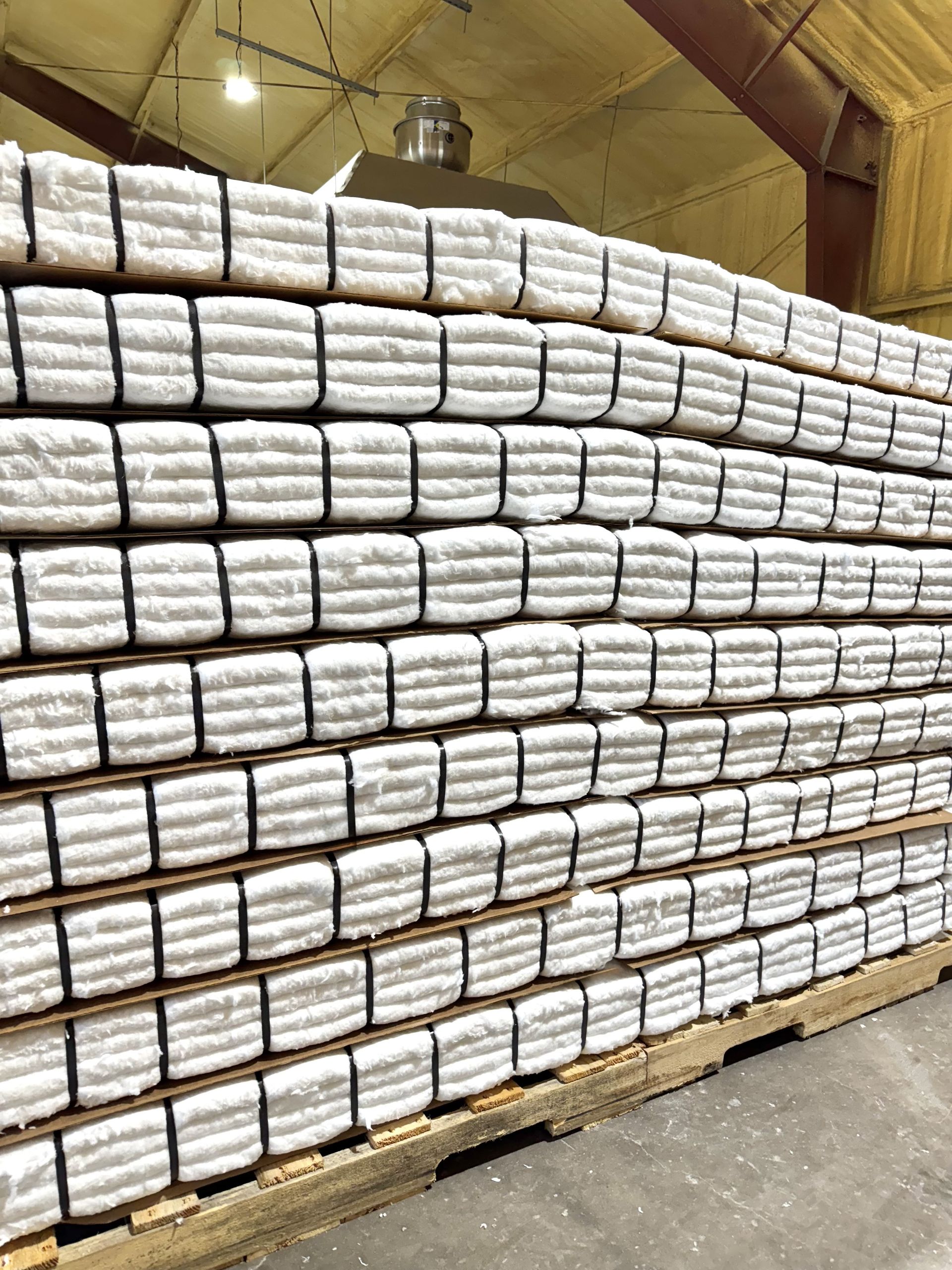 Tan rectangular box with black tape grid, white labels, on reflective black surface.