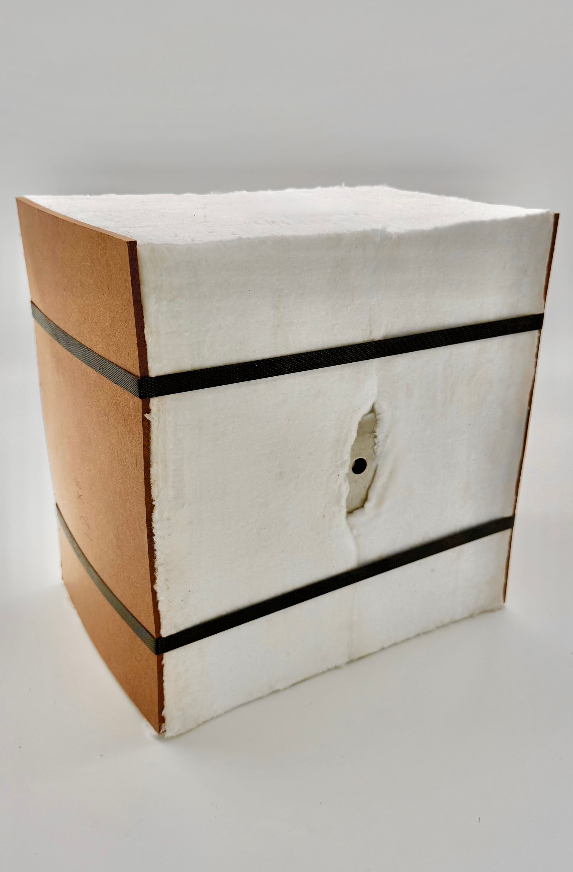 A wooden box with a black ribbon around it.