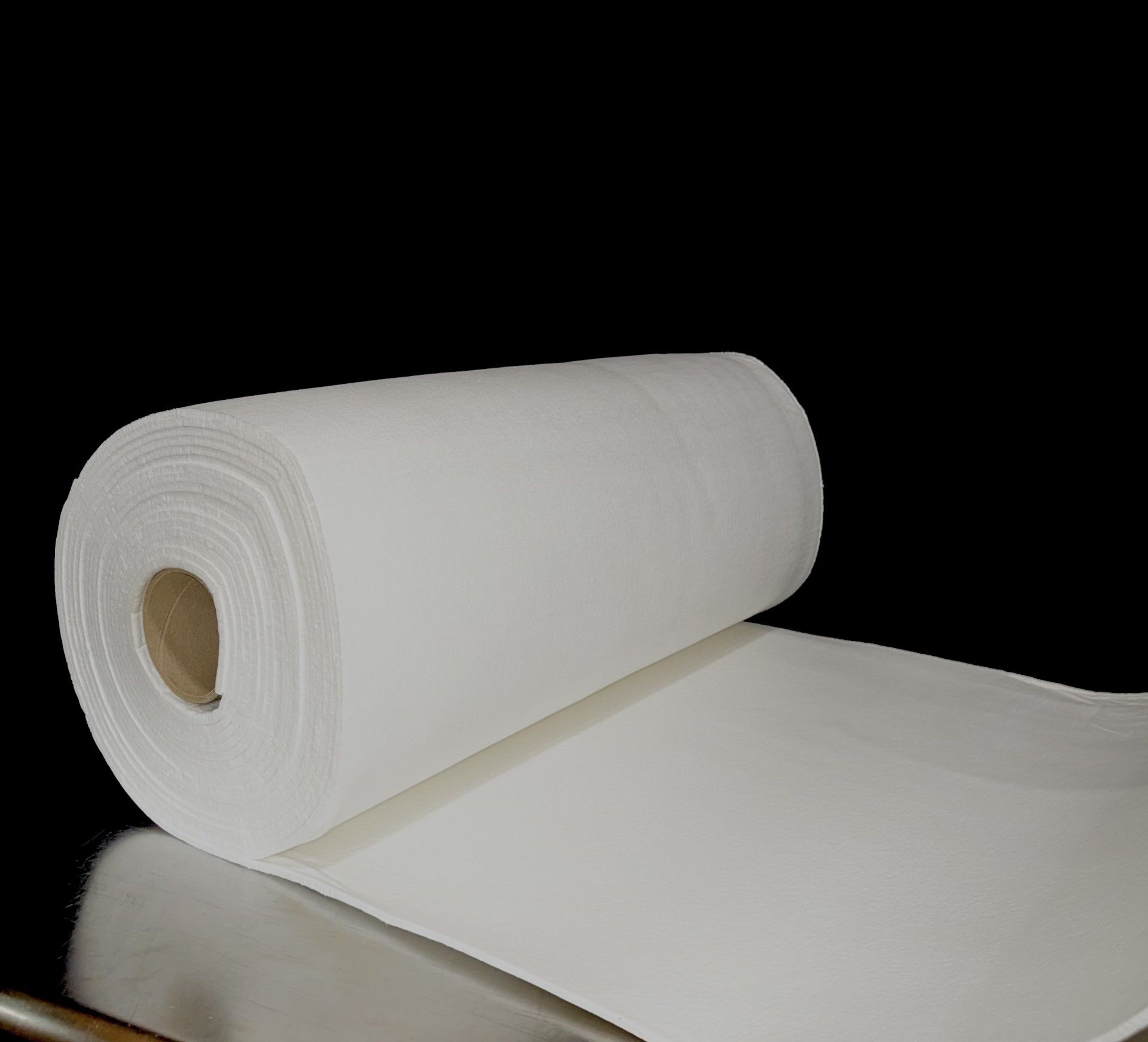 A roll of ceramic fiber paper next to a box