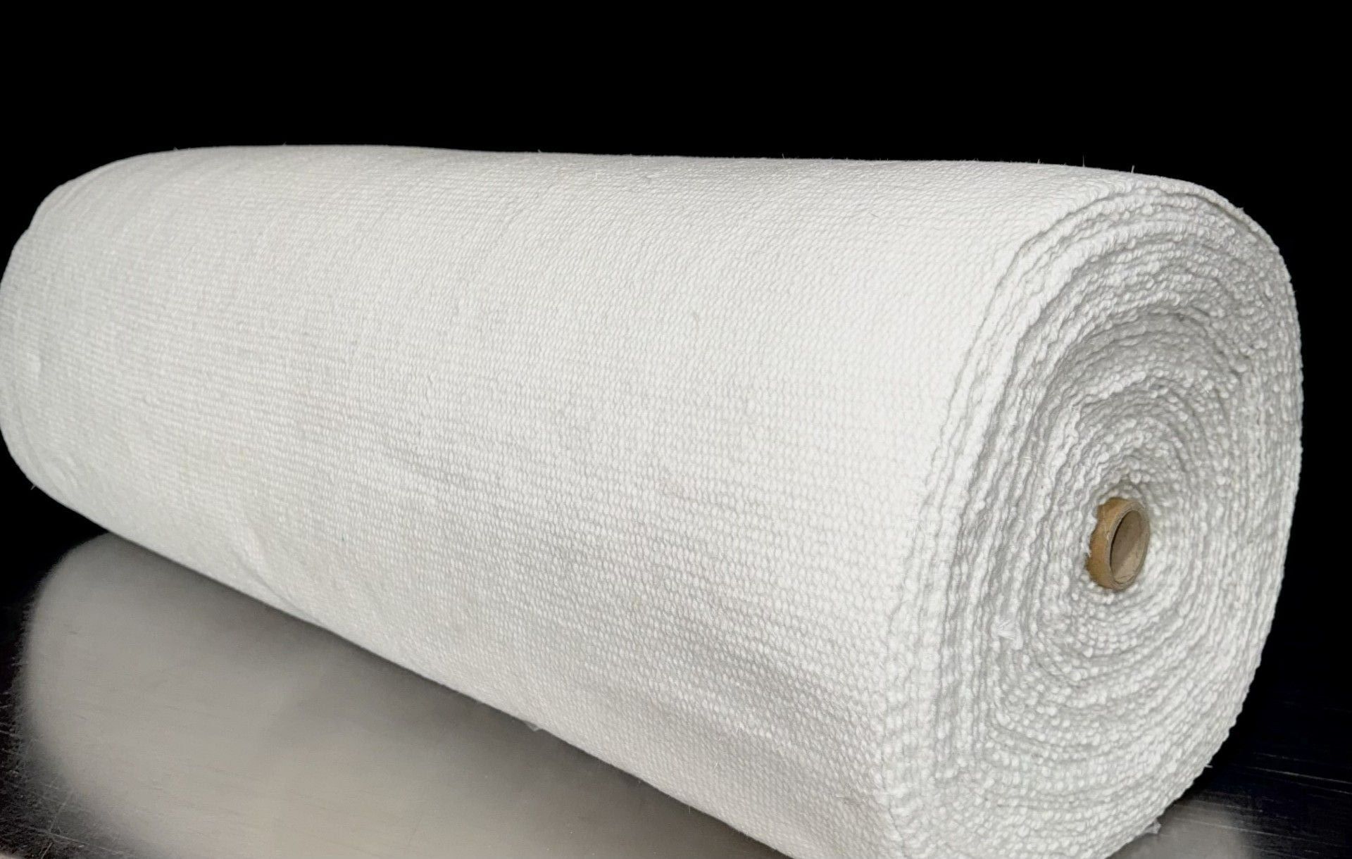 A roll of ceramic fiber paper next to a box
