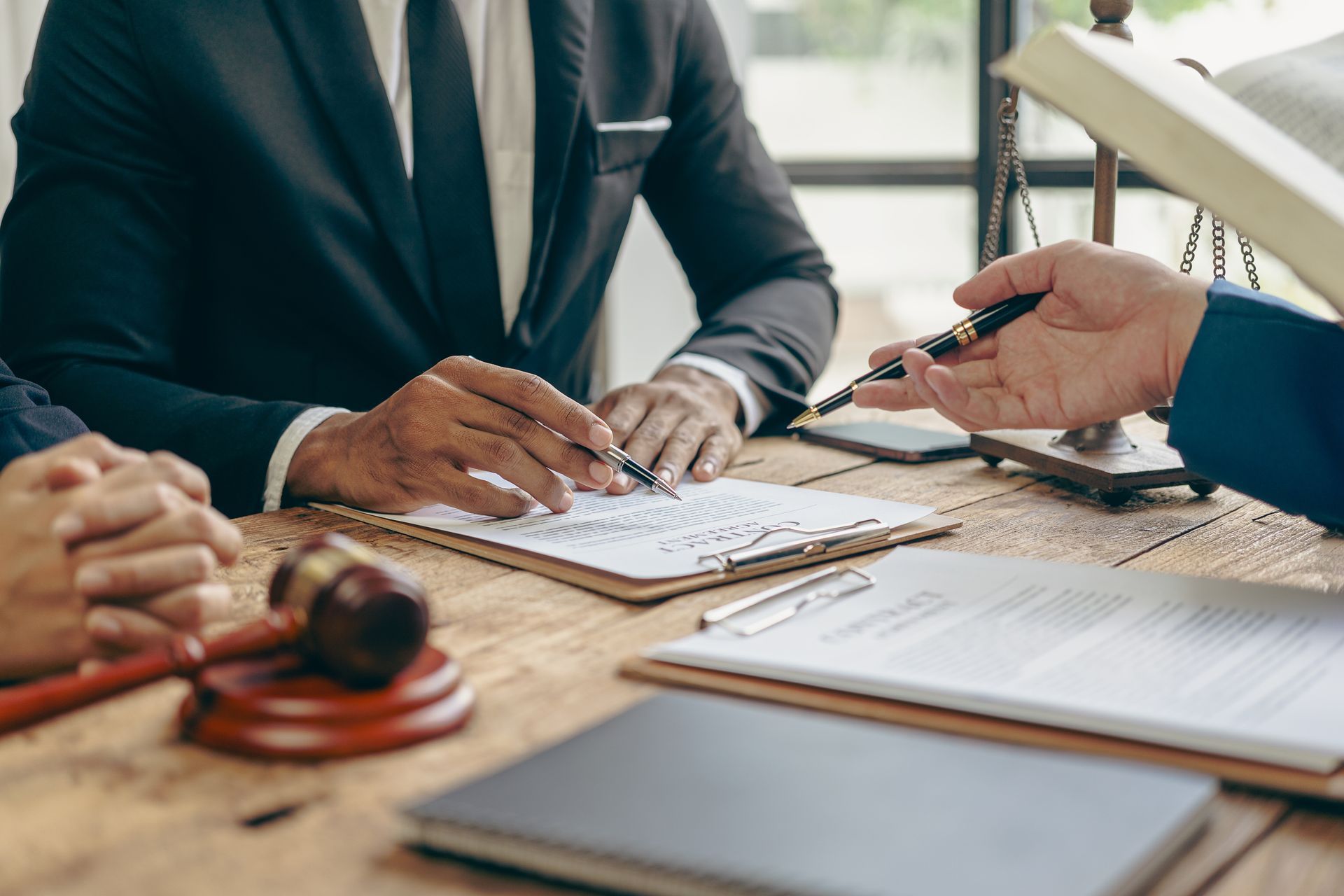 Business meeting with people signing documents at a desk