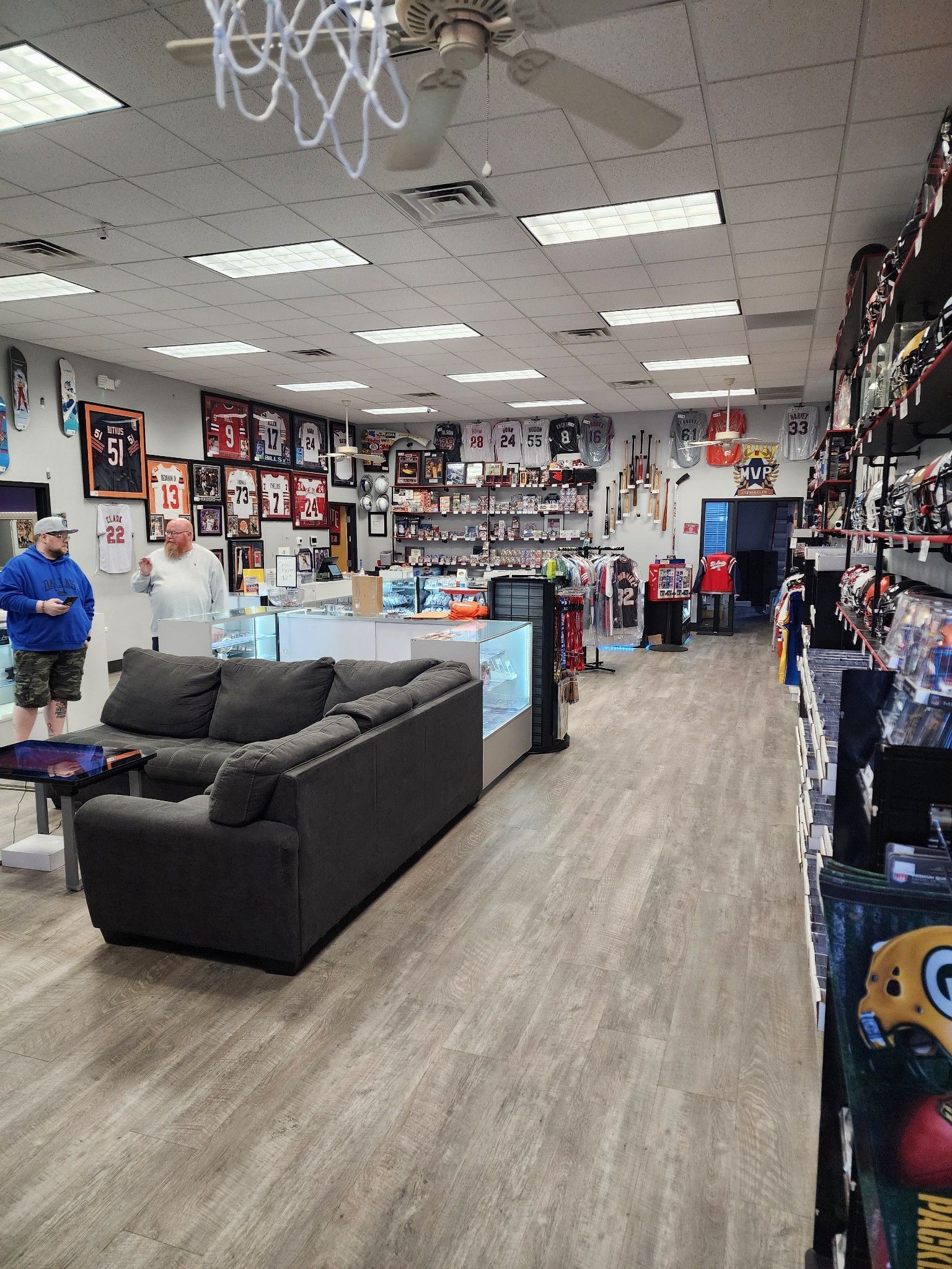 There is a couch in the middle of the room in a store.