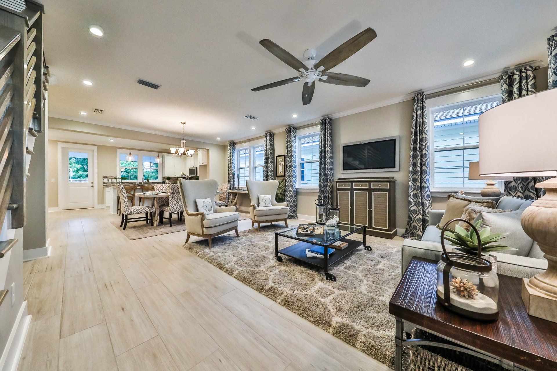 A living room filled with furniture and a ceiling fan.