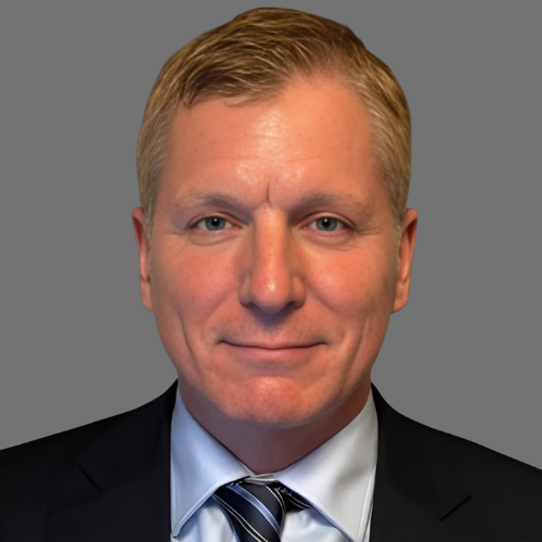 A man in a suit and tie is smiling for the camera.