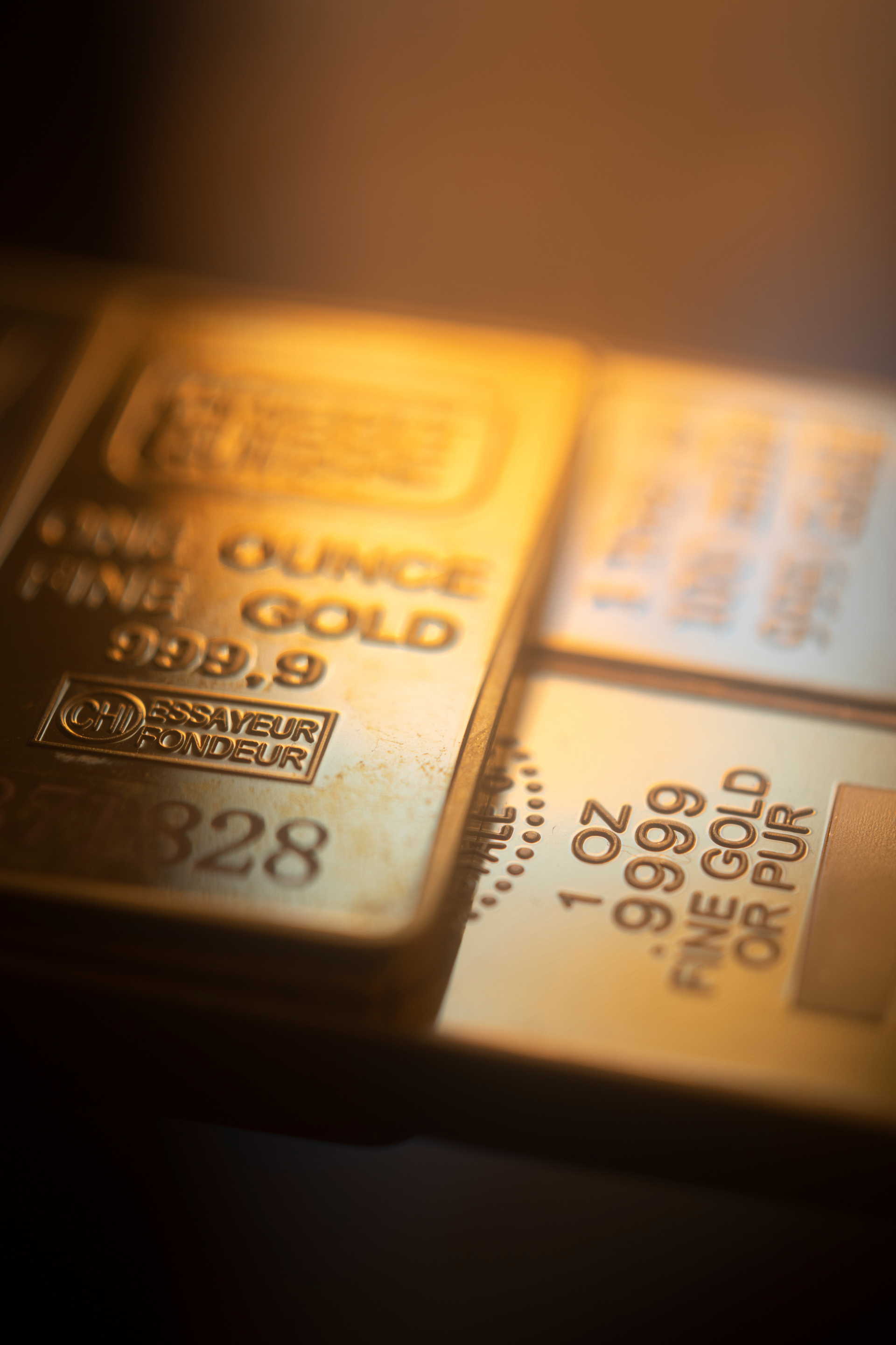 A close up of three gold bars on a table.
