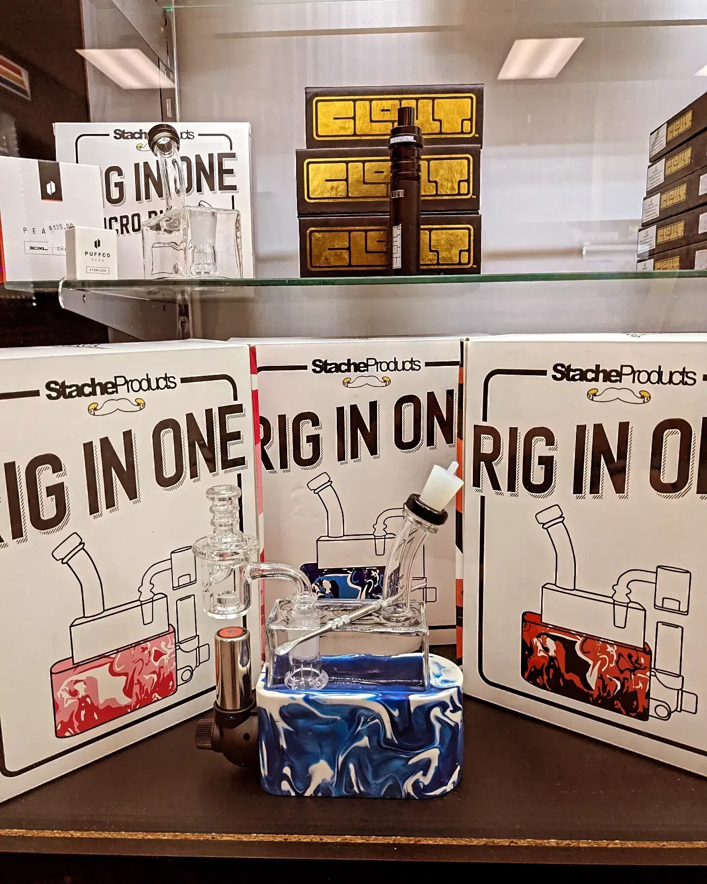 A display case with boxes of rig in one sitting on a table.