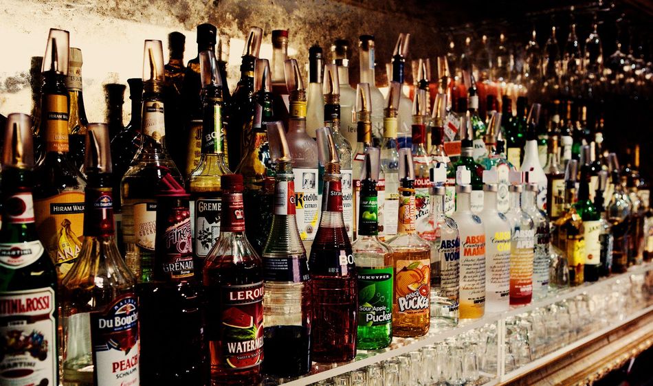 a bar with a lot of bottles of liquor on it