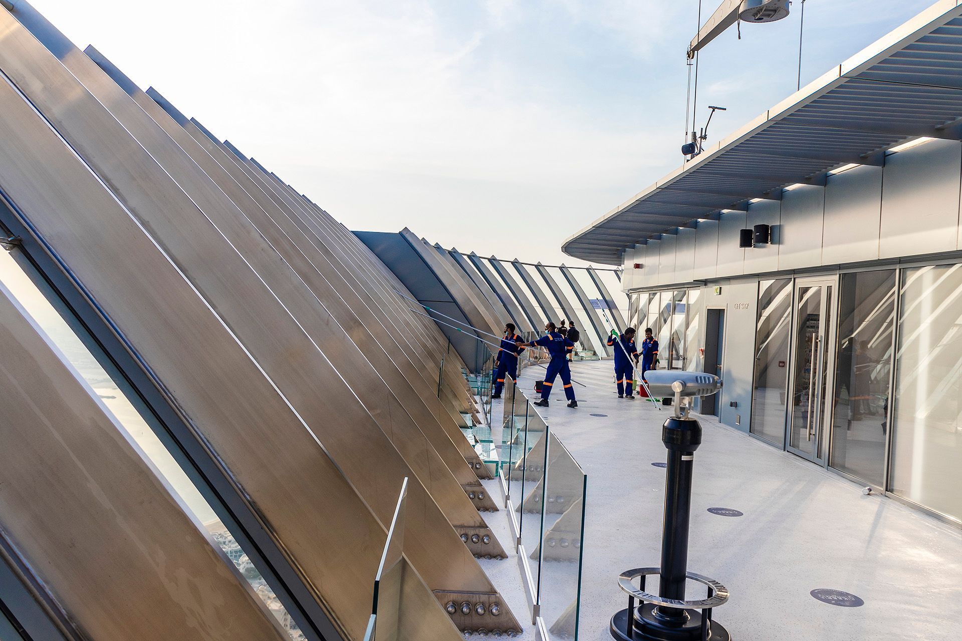 a group of people standing on top of a building