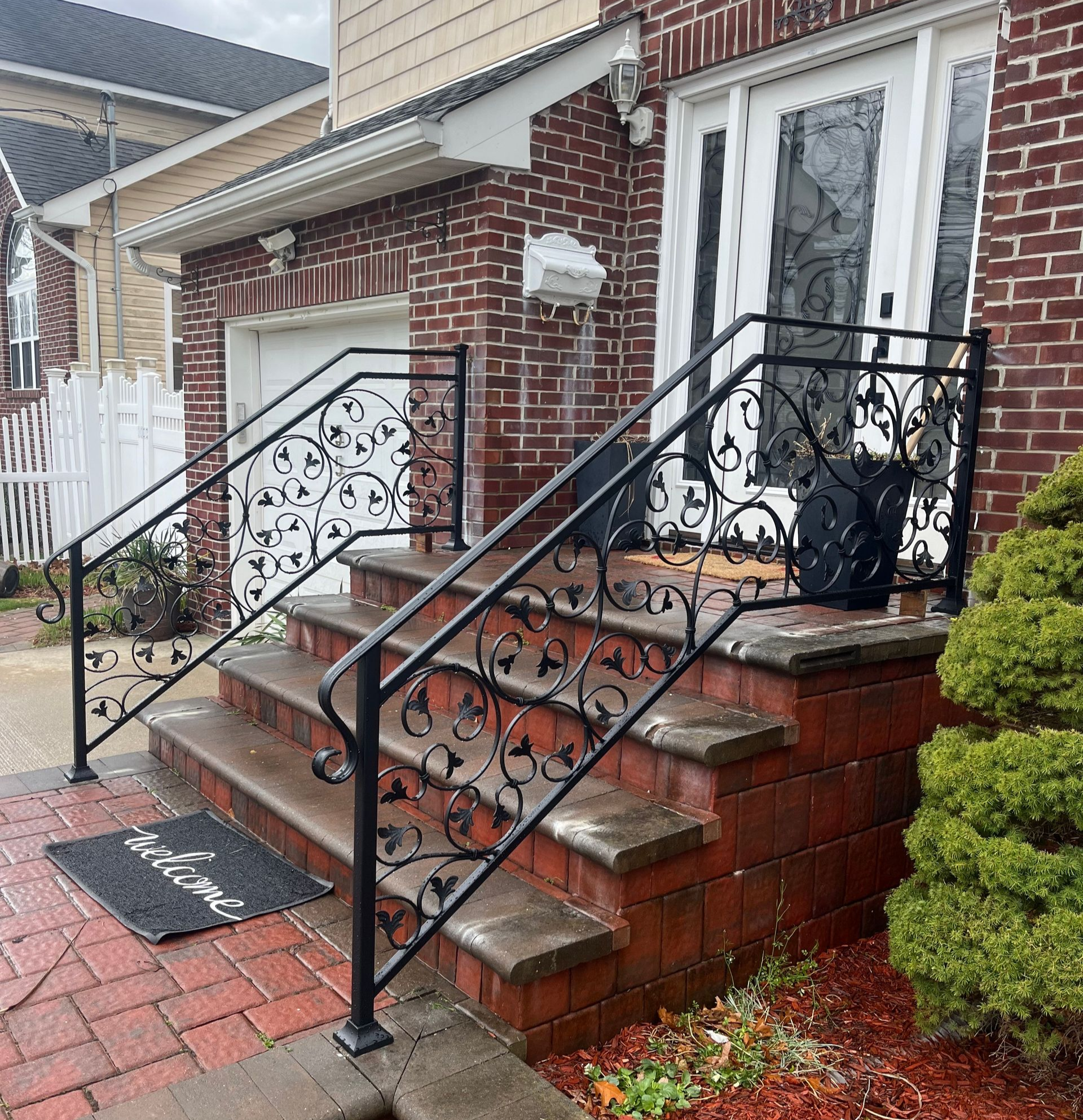 Staircase with light-colored steps, metal railings with gold accents Staircase with light-colored steps, metal railings with gold accents