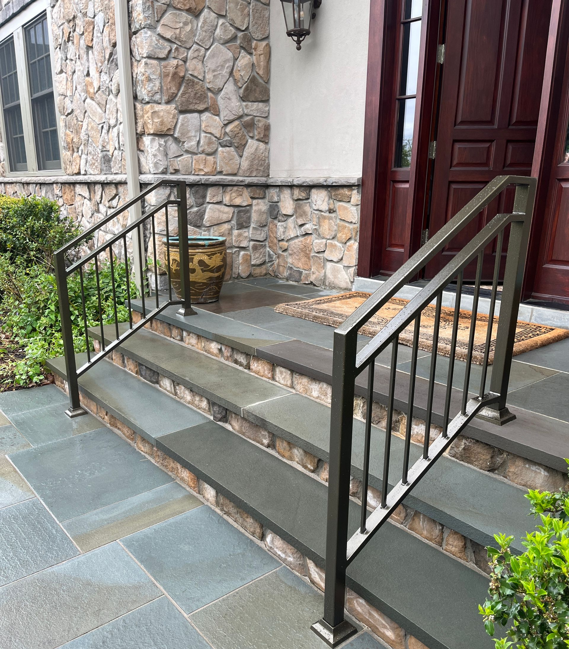 Black wrought iron gate and fence with brick pillars Black wrought iron gate and fence with brick pillars