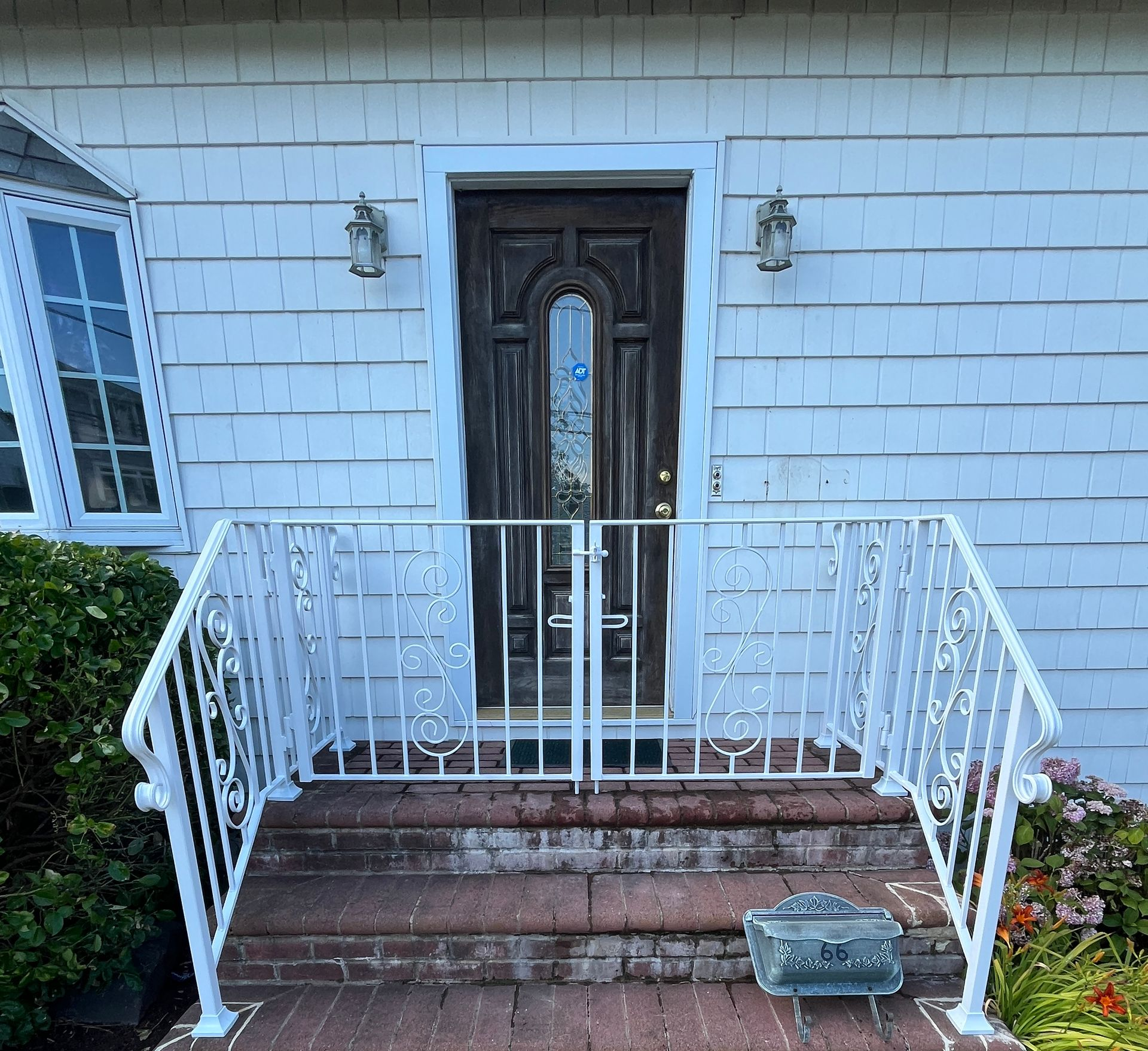 Empty room with a black railing surrounding a staircase Empty room with a black railing surrounding a staircase