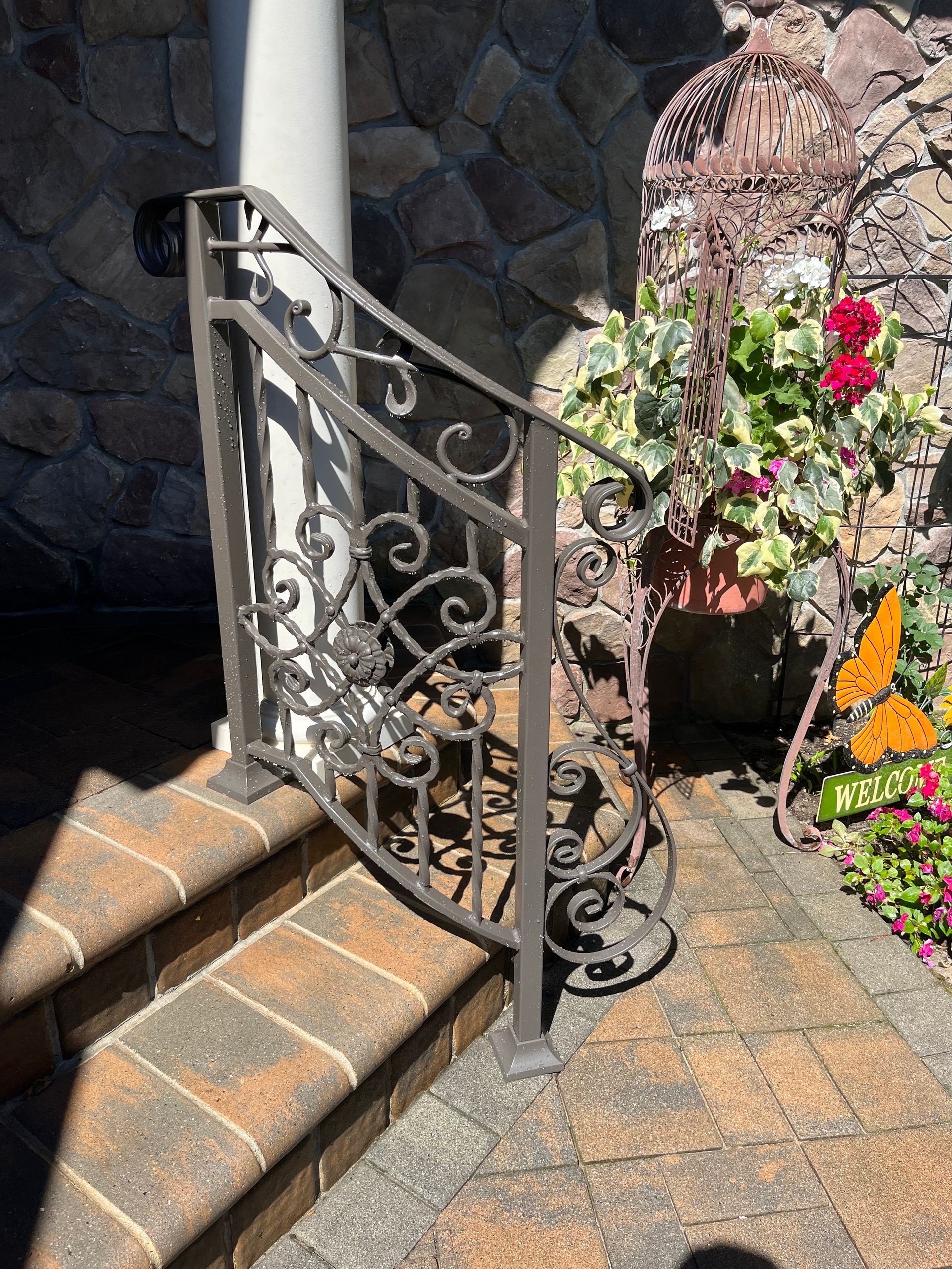 Ornate wrought iron staircase railing, black, against a light wall, with decorative scrollwork and balusters Ornate wrought iron staircase railing, black, against a light wall, with decorative scrollwork and balusters
