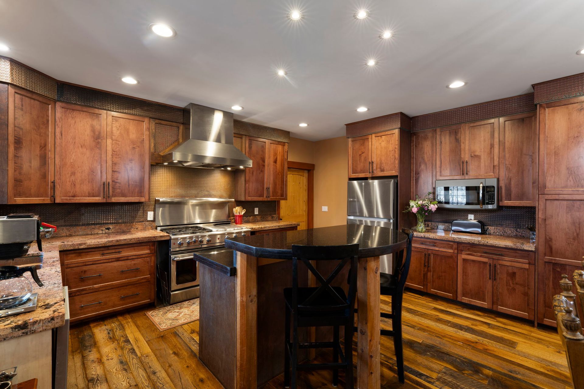 Hallway with wooden floor, stairs, and a door, featuring a decorative chest and a green bowl.