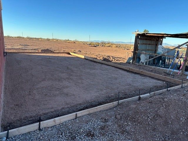 Concrete slab with wood framing; outdoors, desert setting.