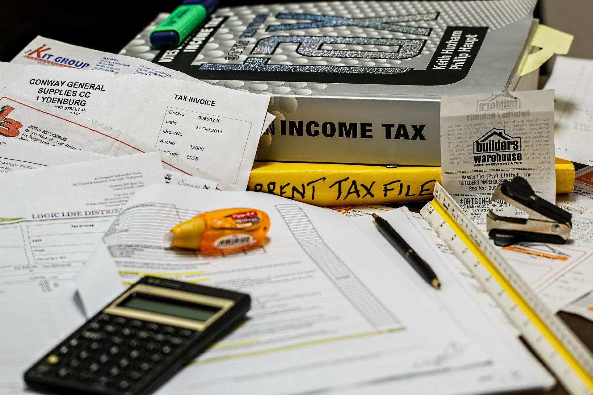 Tax documents and a calculator on a desk