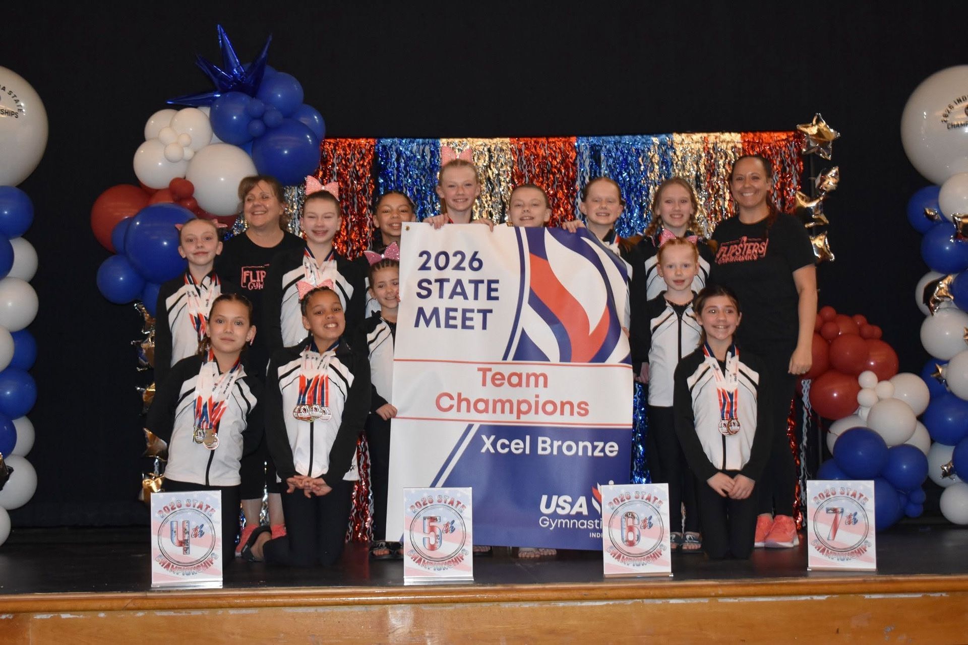 Team photo at 2026 State Meet, holding a 