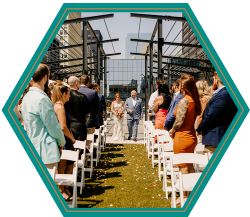 A bride and groom are walking down the aisle at a wedding ceremony.