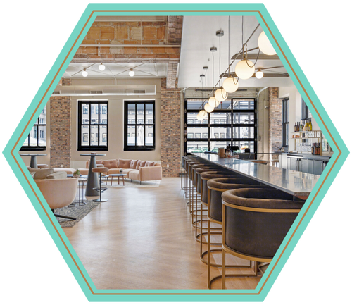 A large room with a long bar and a lot of windows.