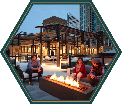 A group of people are sitting around a fire pit.