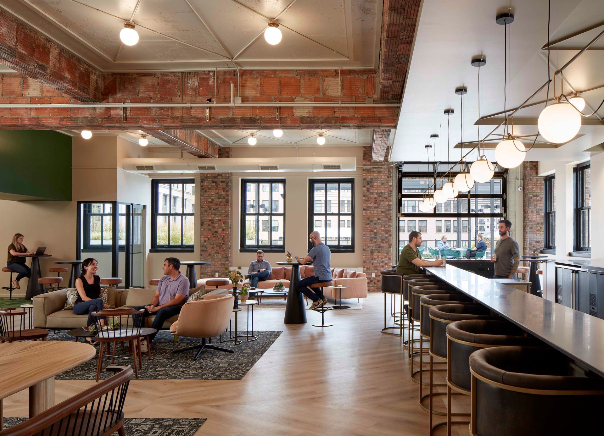 A group of people are sitting at tables in a large room.