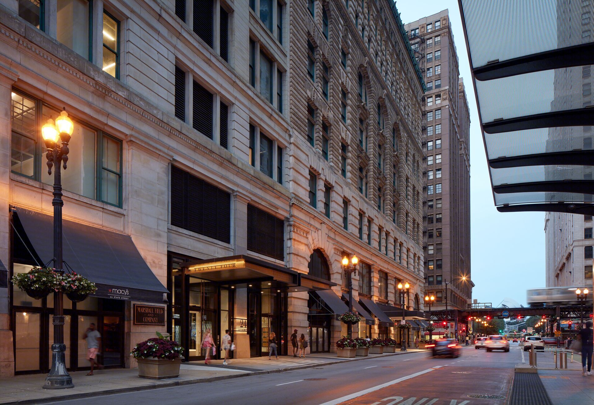 A city street with a large building in the background