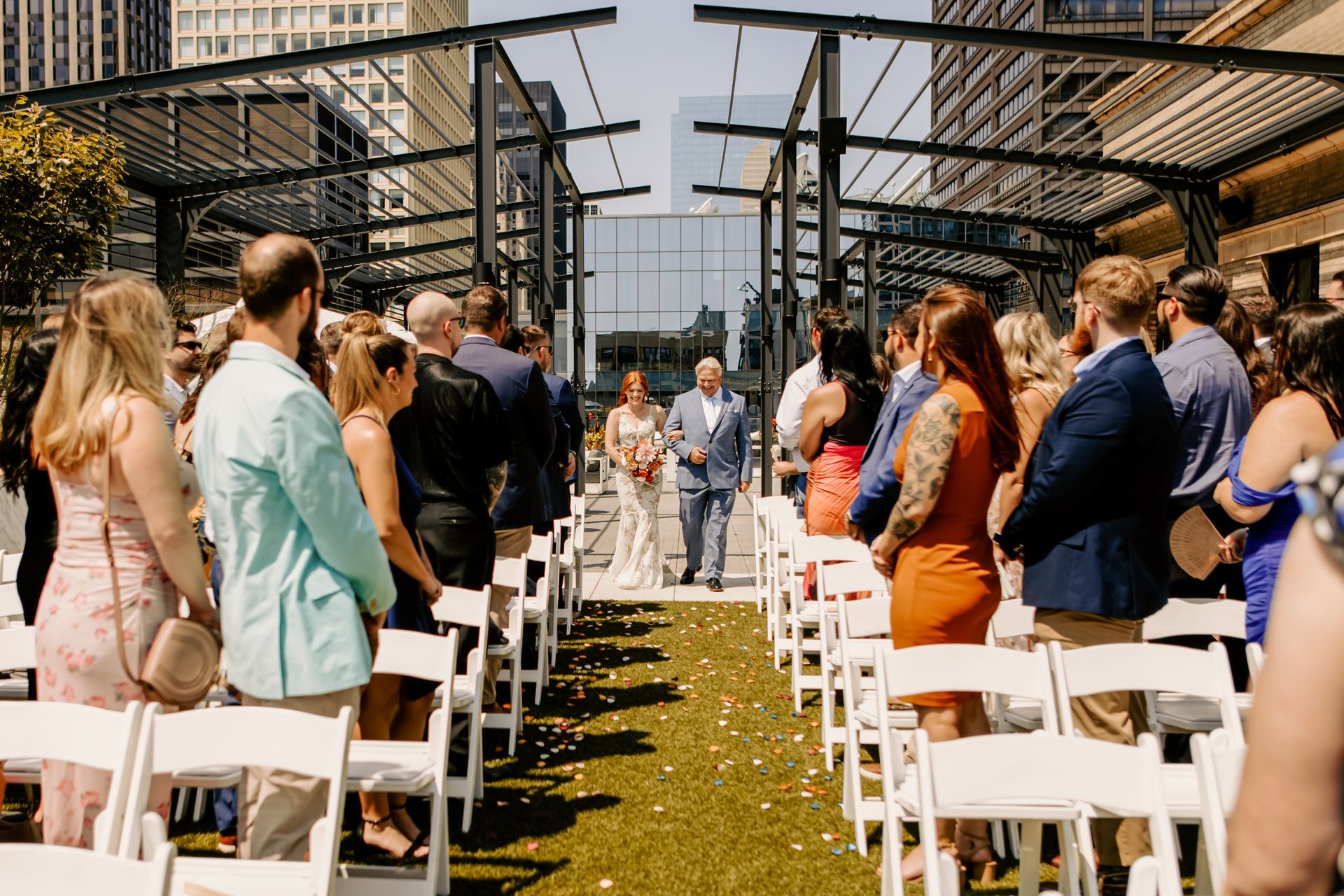 A bride and groom are walking down the aisle at a wedding ceremony.
