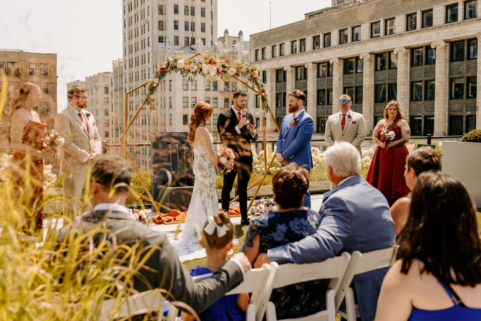 A bride and groom are getting married in front of a crowd of people.