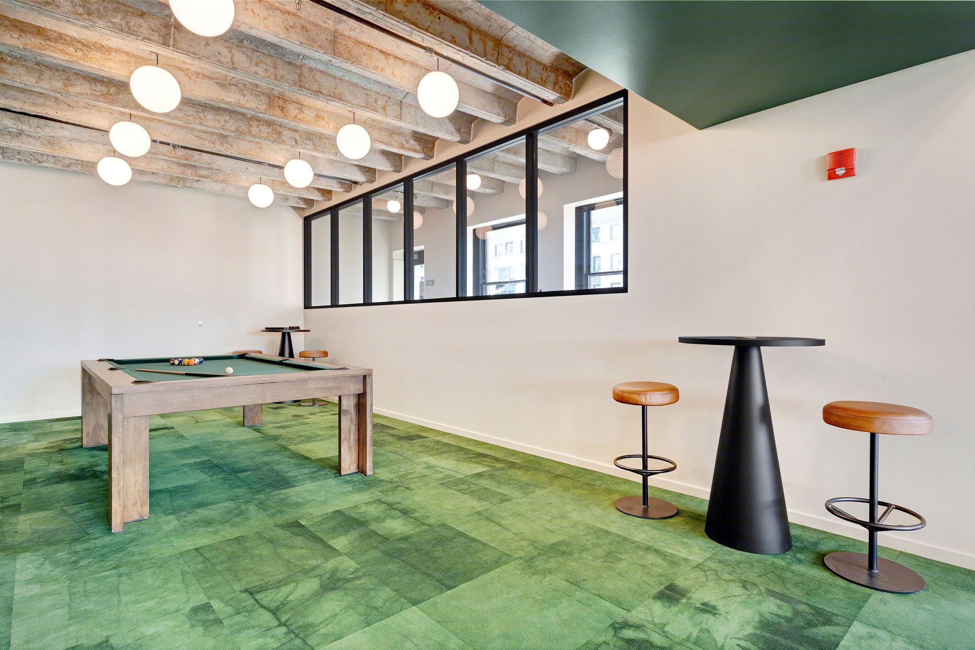 There is a pool table in the middle of the room.