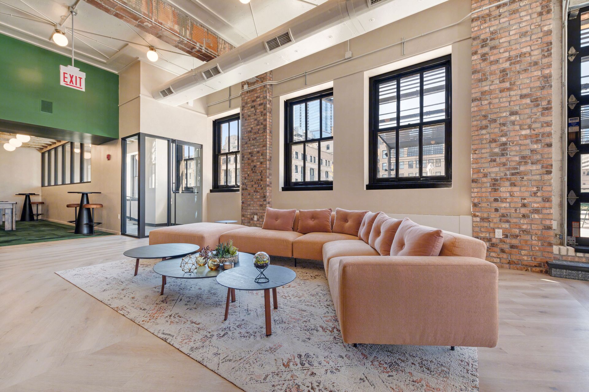 A living room with a couch , two coffee tables , and two windows.