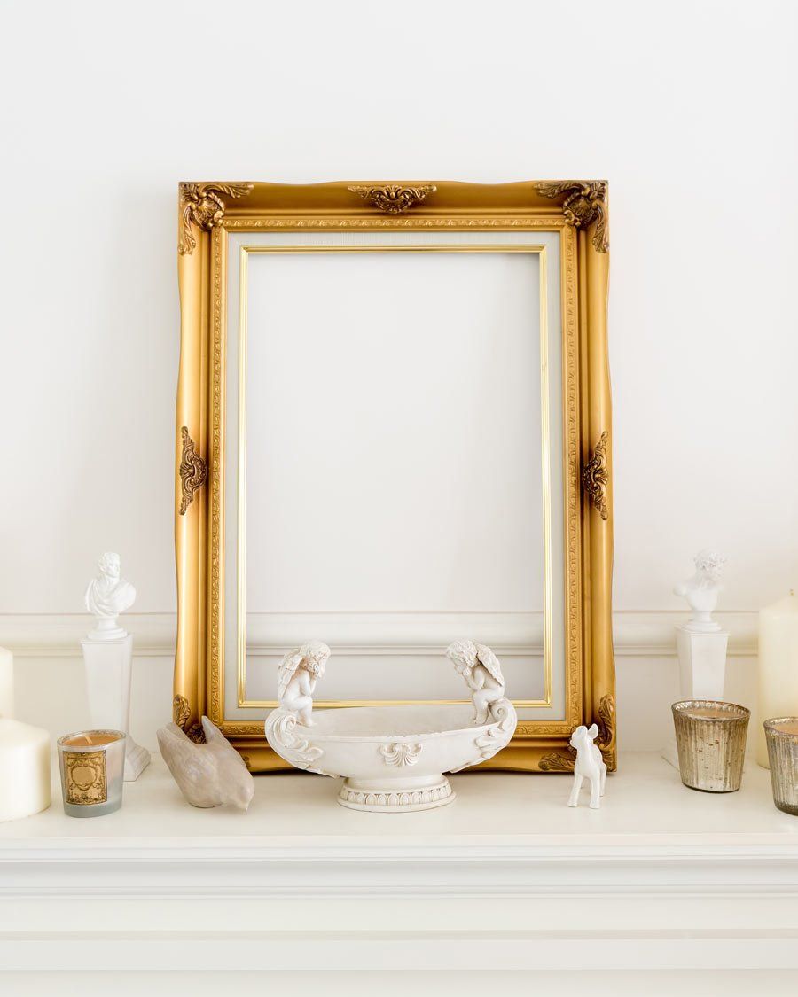 gold frame on white mantle