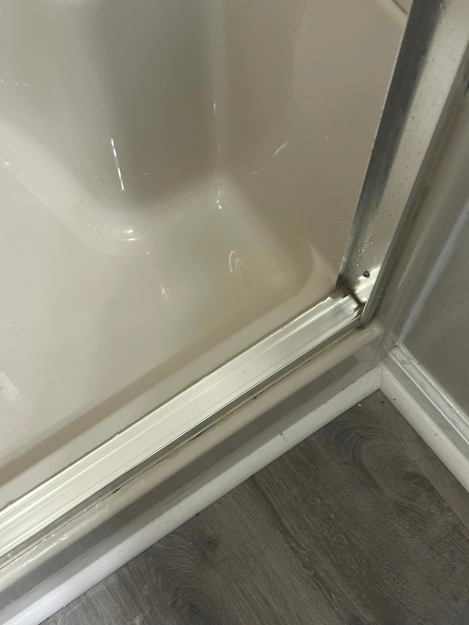 A close up of a shower door in a bathroom.