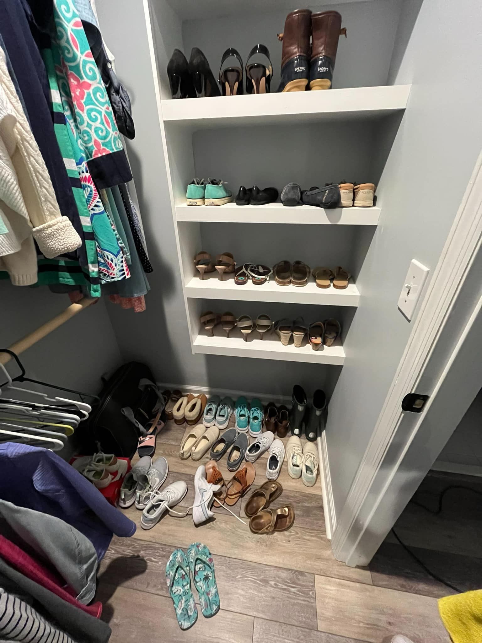 Before of a closet filled with lots of shoes and clothes.