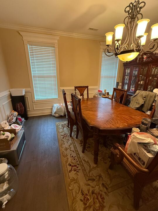 Closet with several gray storage bins on shelves; the bins are organized and labeled.