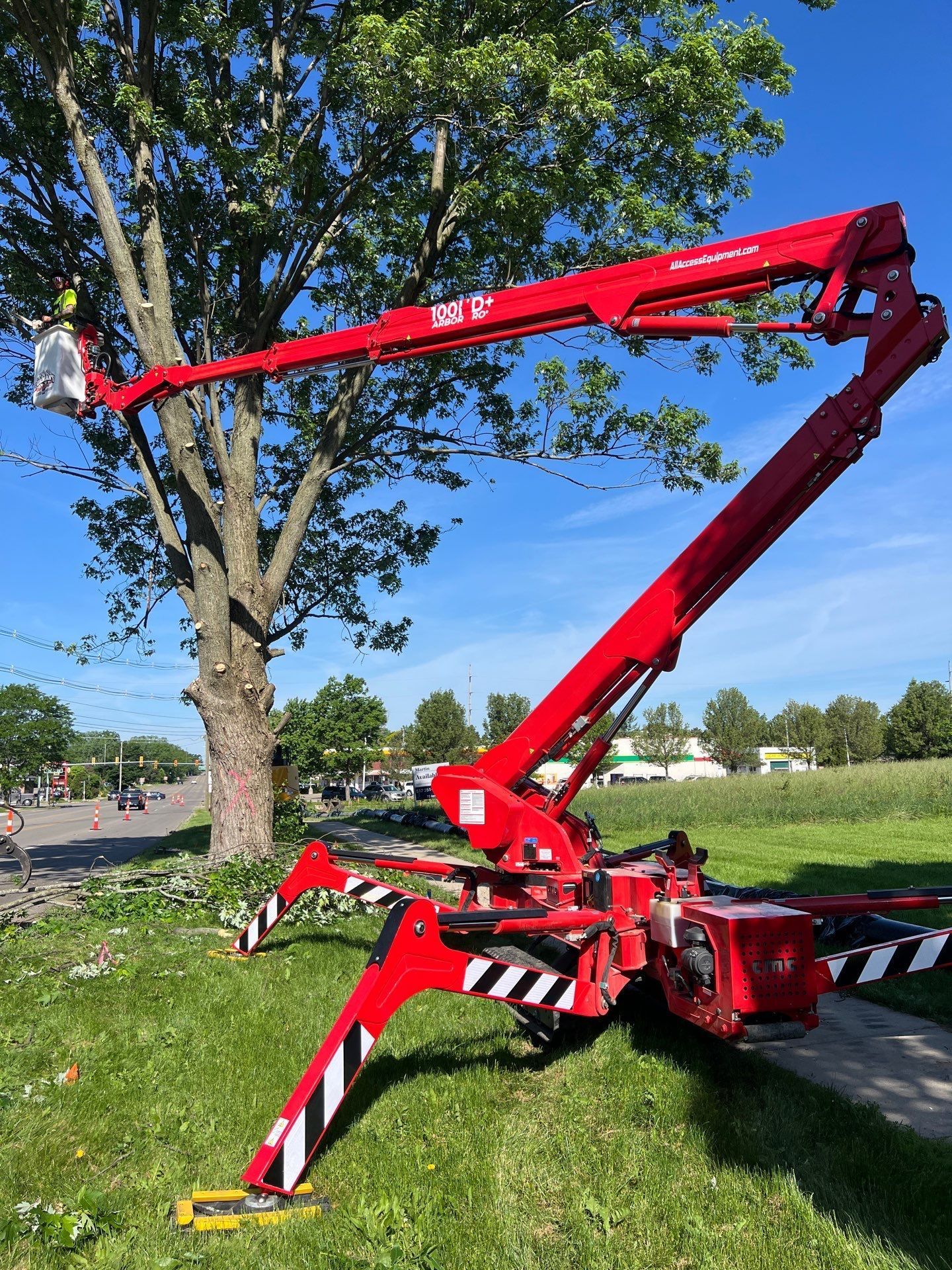 A truck with a crane attached to it is parked in front of a house.