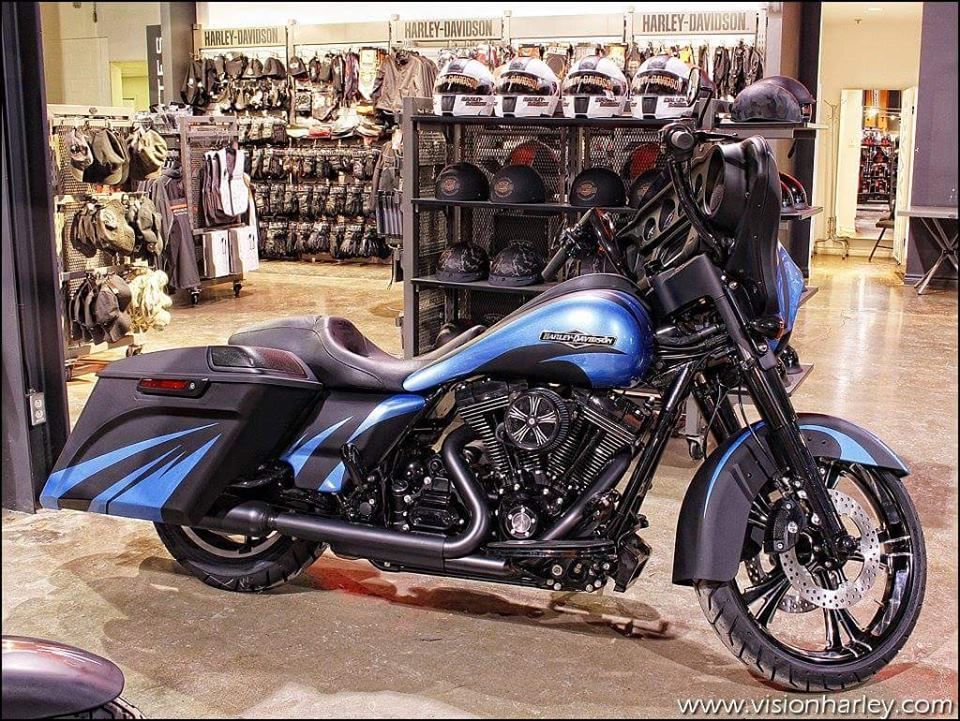 A blue and black harley davidson motorcycle is parked in a store